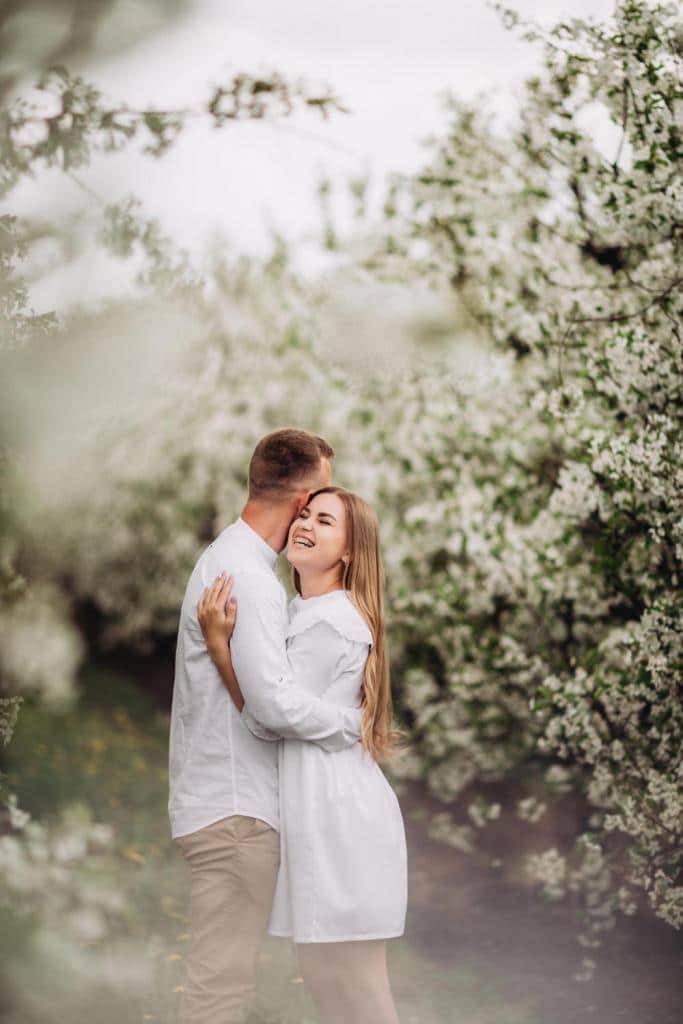 happy family couple love spring blooming apple orchard happy family enjoy each other while walking garden man holds woman s hand family relationships